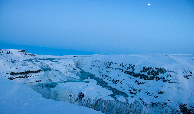 Måne över Gullfoss, fruset vattenfall på Island