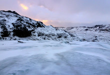 Vintersolen färgar himlen Sólheimajökull, Island