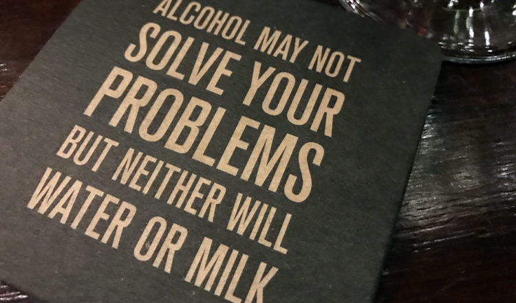 Drickunderlägg med texten Alcohol may not solve your problems, but never will water or milk. På Cleaver East By Oliver Dunne